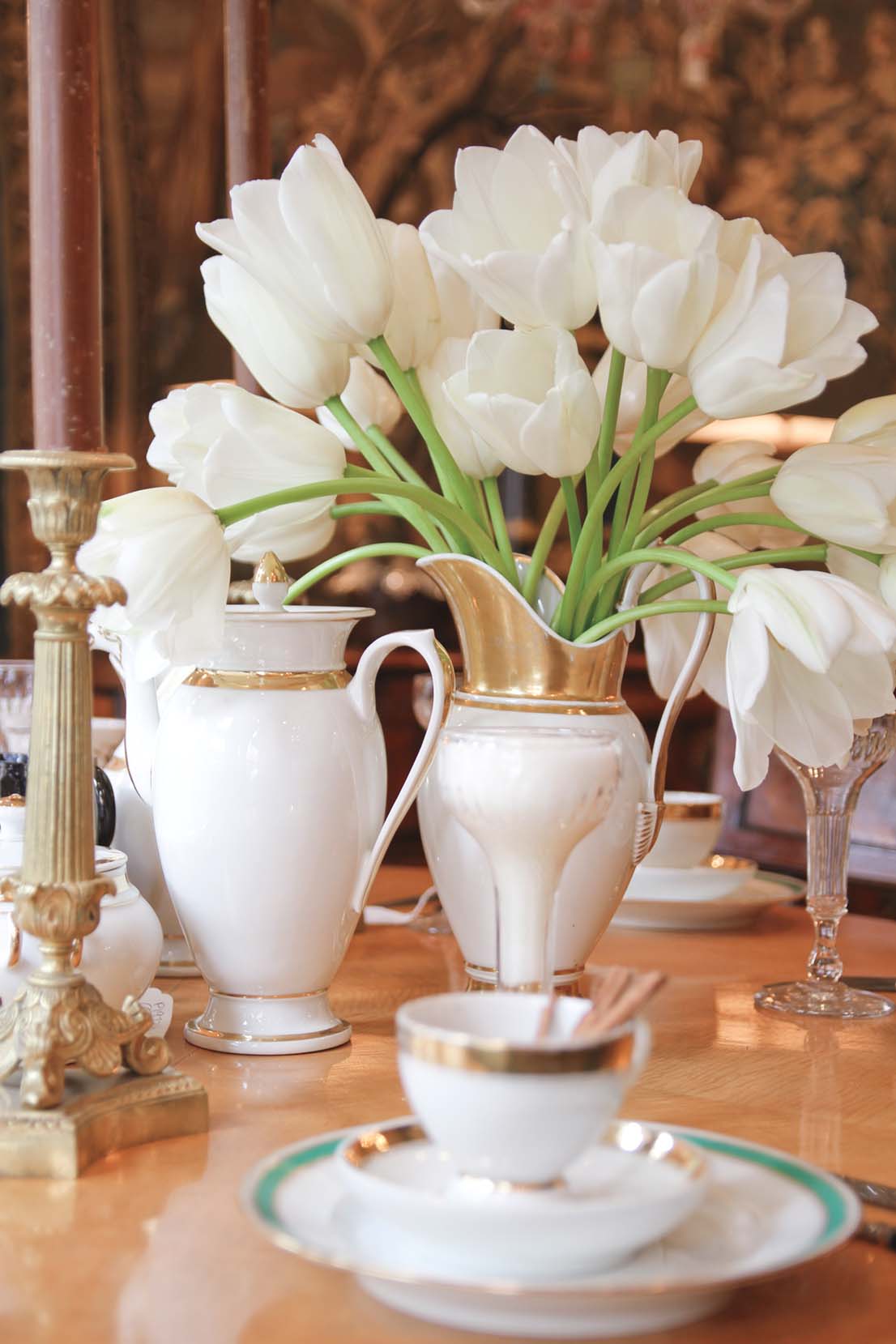 white tulips in an antique pitcher