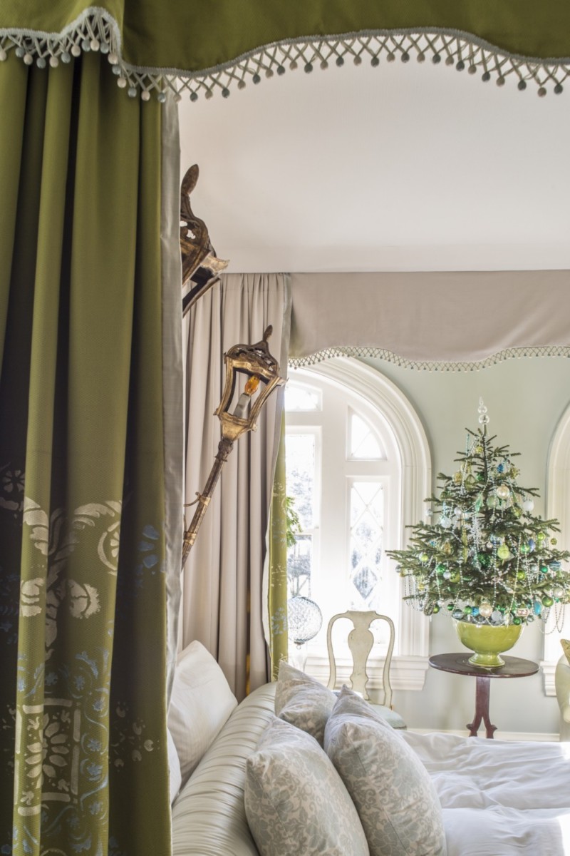 Pale green bedroom with rich olive green fabric canopy