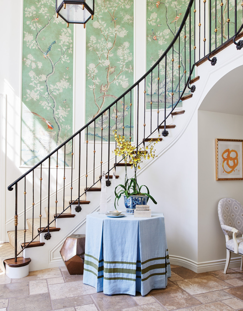 stairwell in designer Mark Sikes' foyer, wallpapered in a scenic botanical pattern.