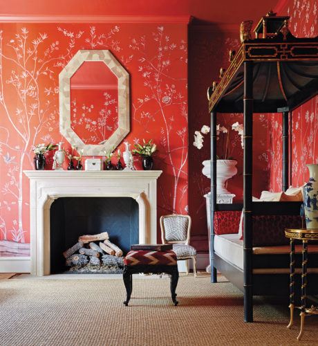 Ceylon et Cie’s signature pagoda daybed becomes the perfect complement for a saturated de Gournay chinoiserie wallpaper in a rich vermilion red. | Photo by Stephen Karlisch