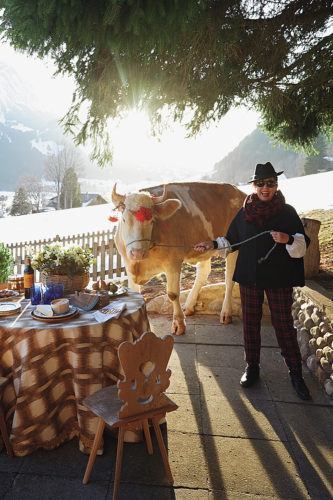 Michelle Nussbaumer at her Swiss chalet with her milk cow, Cindy. | Photo by Melanie Acevedo 