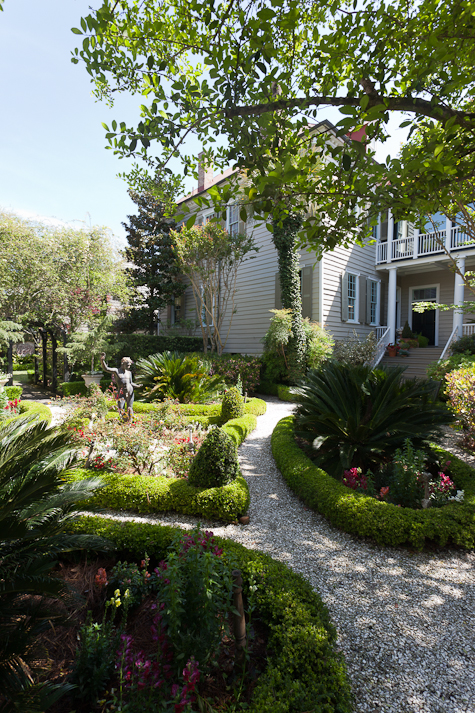 A lush garden wraps around a house in Charleston.