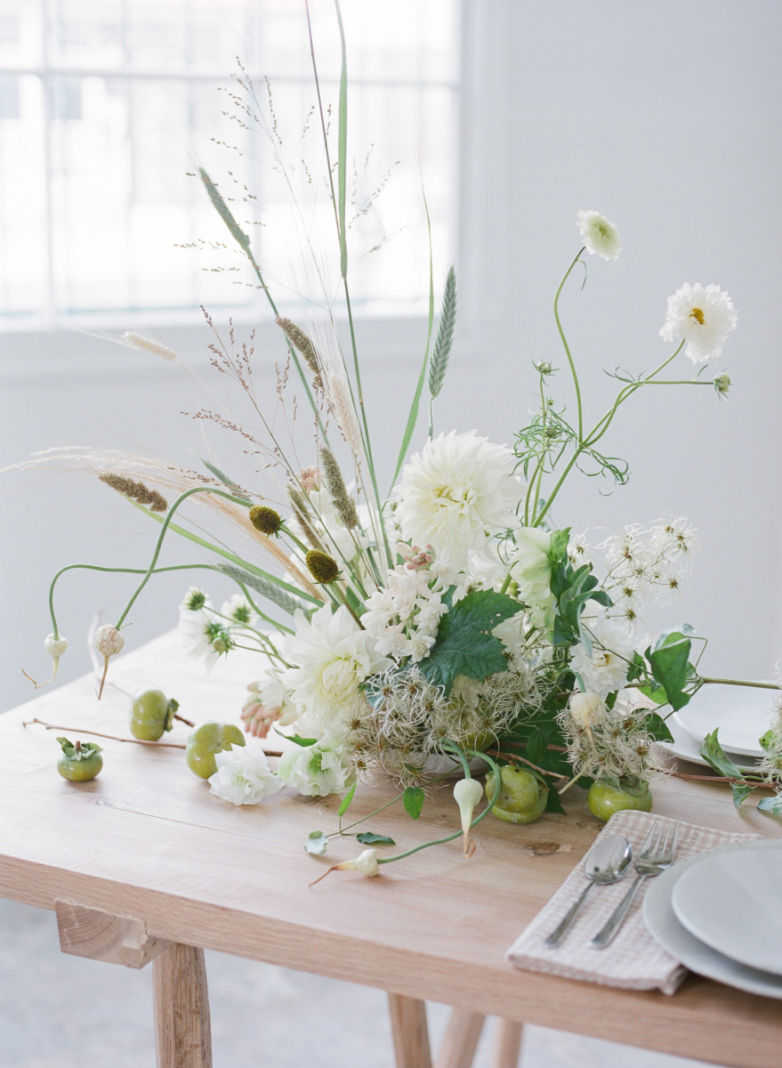 White dahlias are the centerpiece of an arrangement.