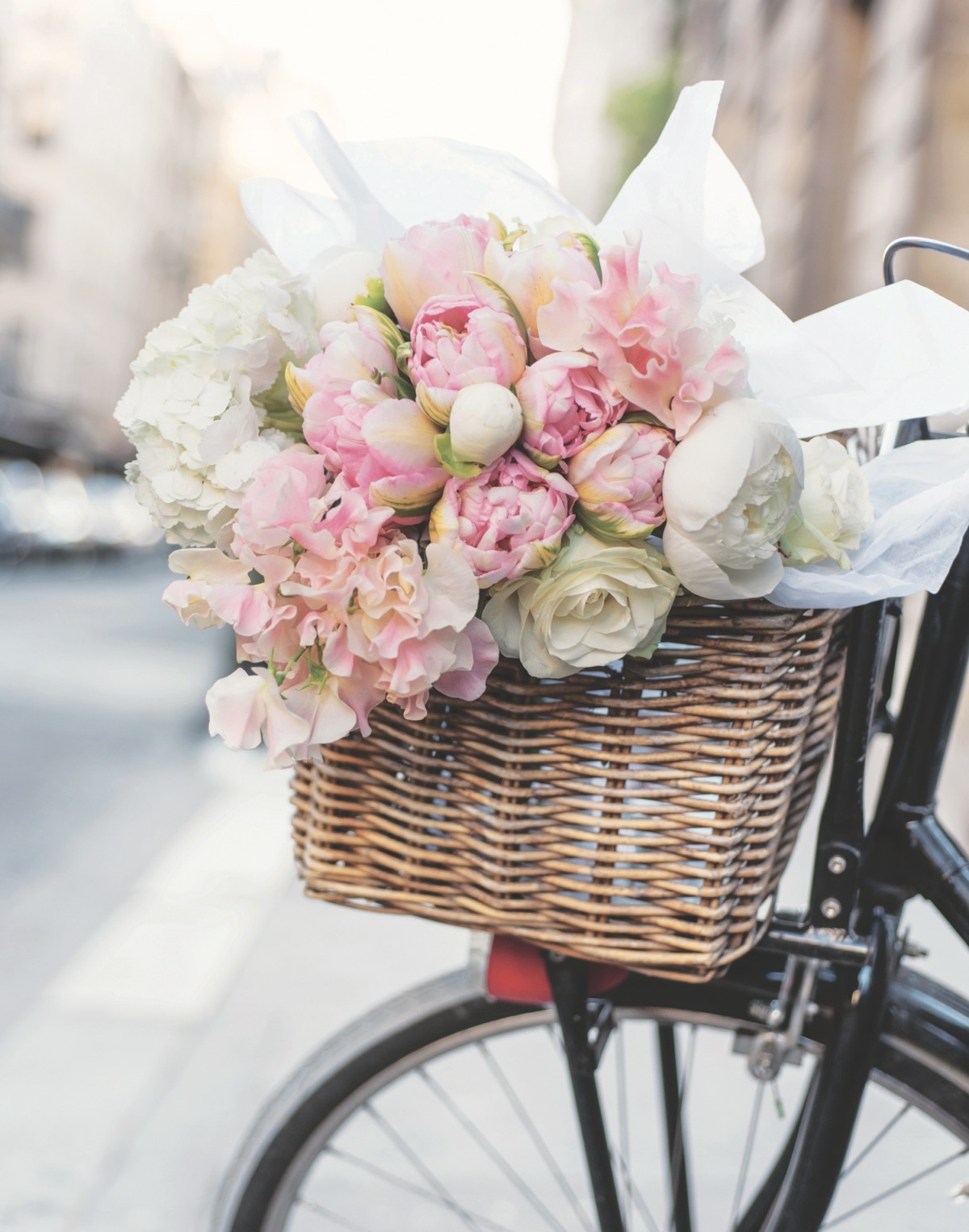 Bicycle basket with peony arrangement in shades of pink