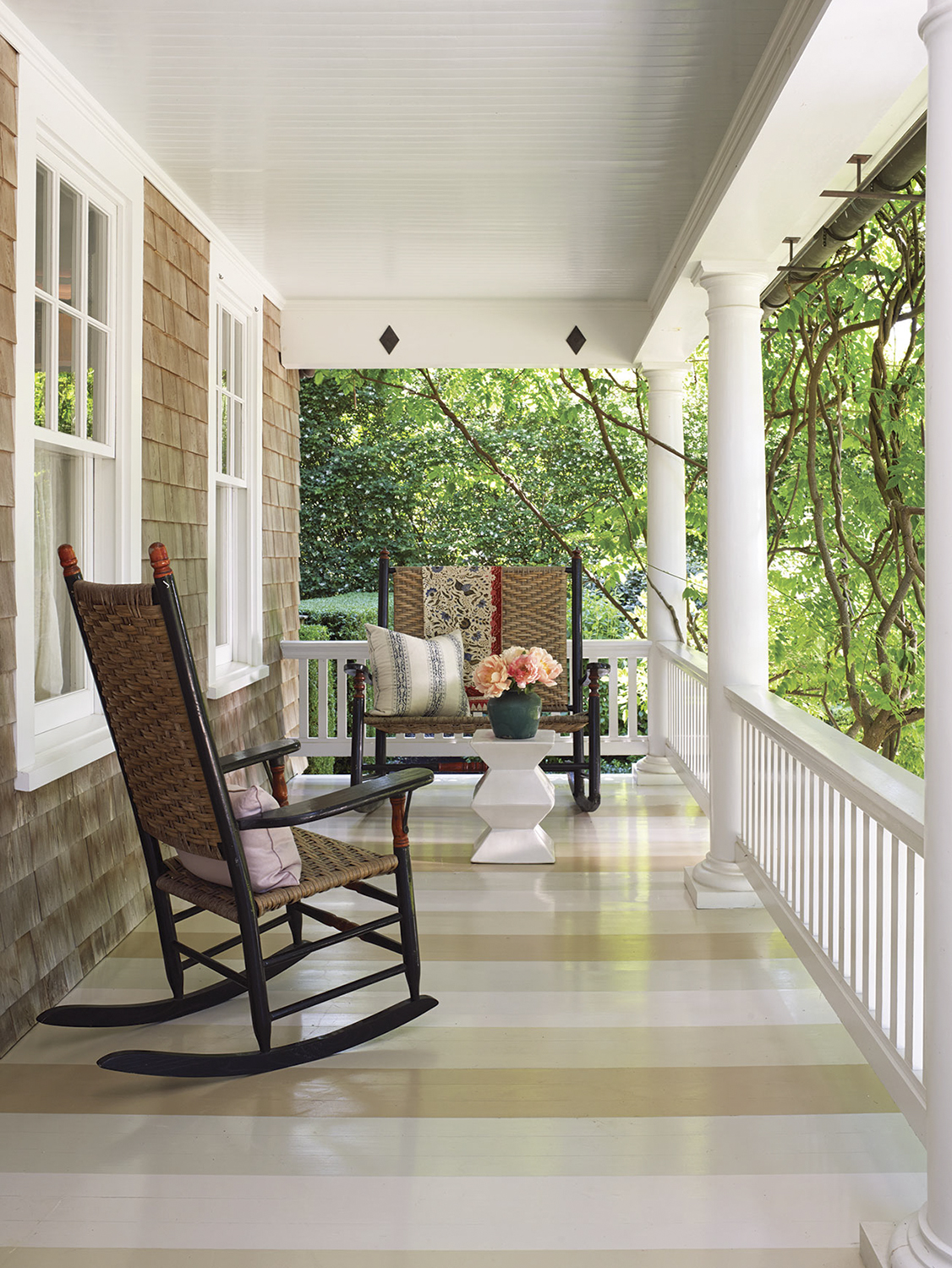 A porch with a painted striped floor. 