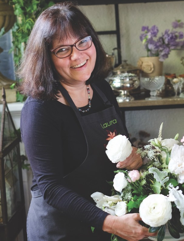 Portrait of Laura Iarocci working on arrangement in flower shop