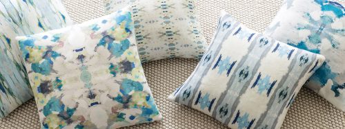 Four throw pillows in various airy patterns featuring shades of blue