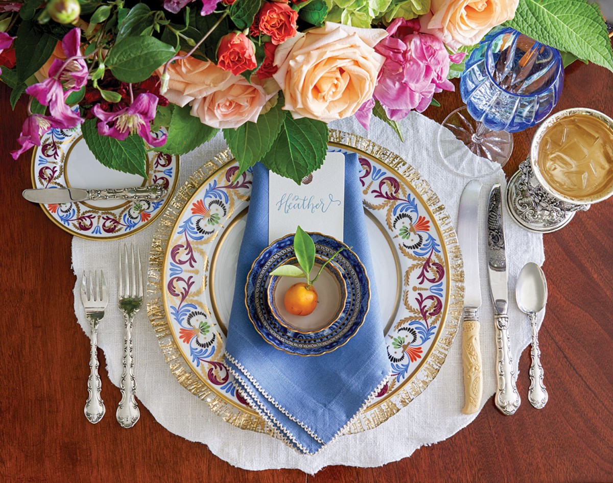 Elegant table setting with lush florals and blue napkin includes the ‘Gosford’ dinner plate and side plate 