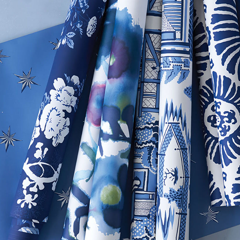 7 rolls of blue and white wallpaper in various patterns