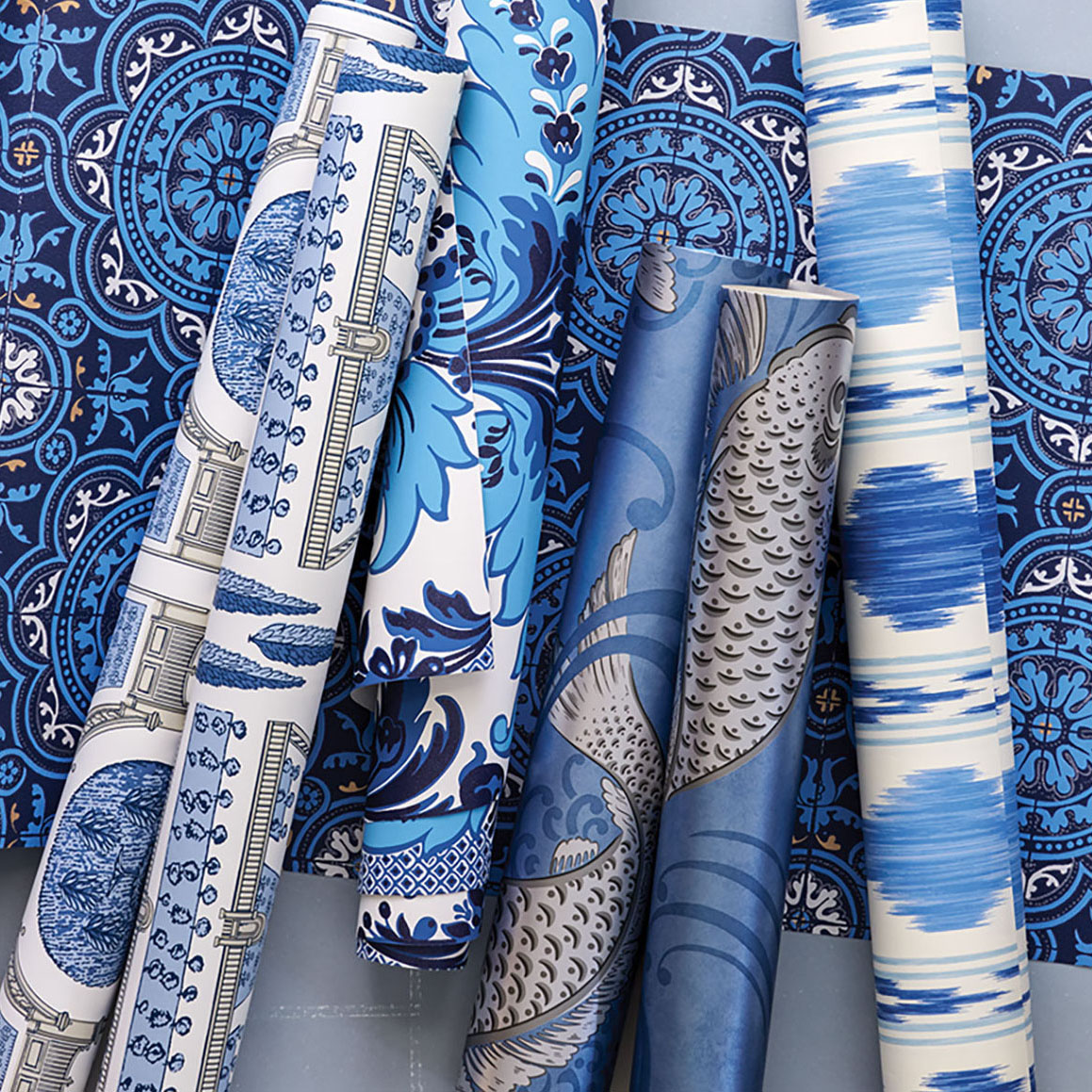 6 rolls of blue and white wallpaper in various patterns