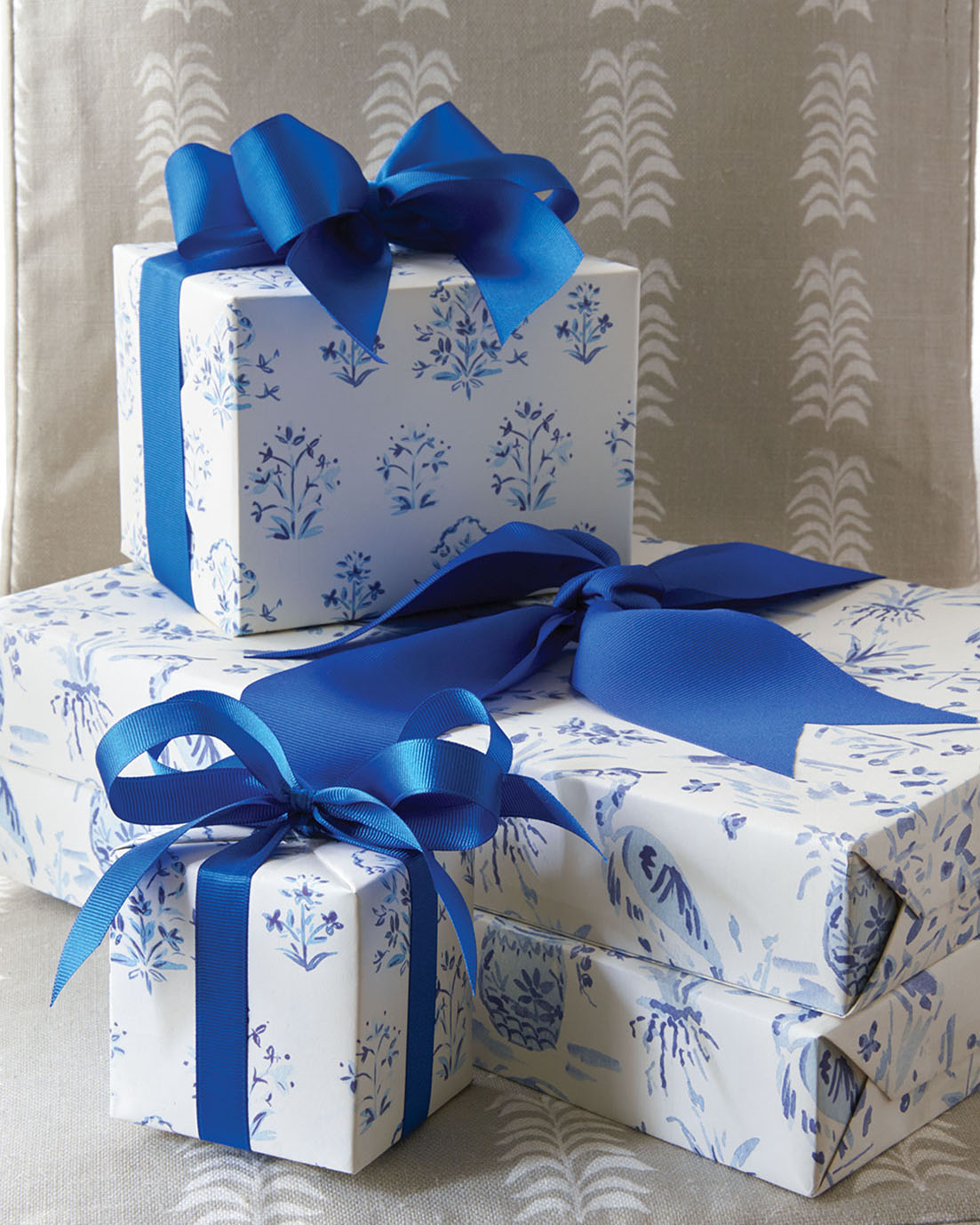 Gift boxes wrapped in blue and white paper and tied with blue ribbon