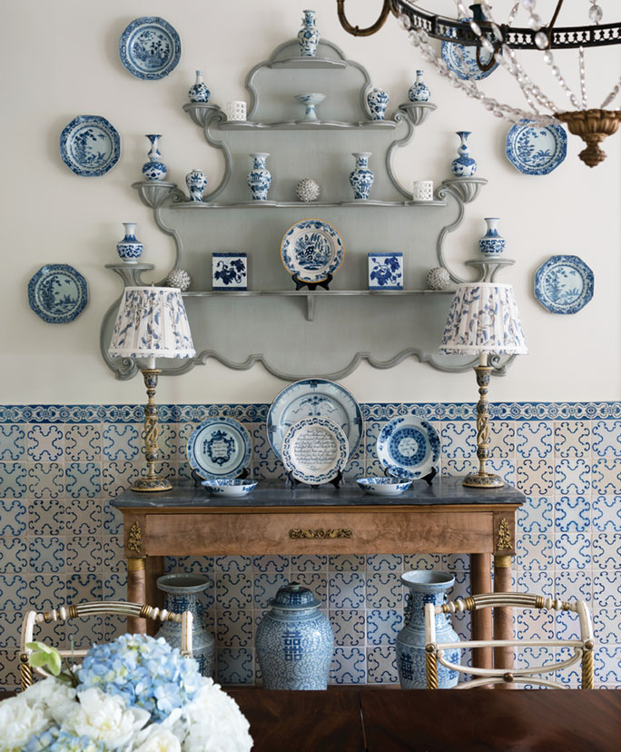 Cathy Kincaid dining room with blue and white ceramic collection, blue and white tile on wall.