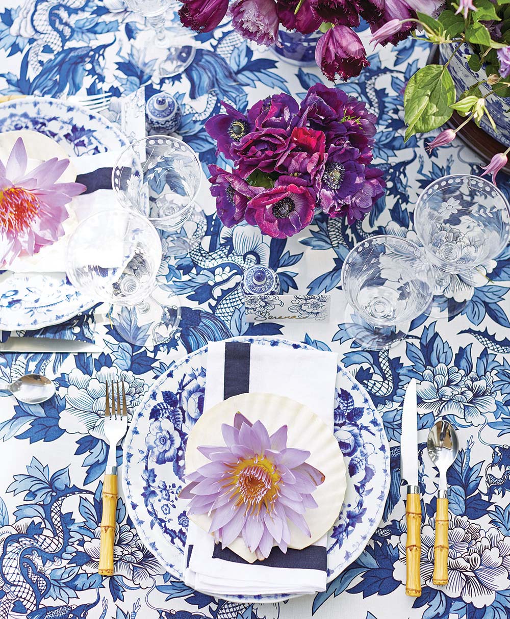 Turner layered blue-and-white patterns, setting Williams Sonoma’s Japanese Garden dinnerware on Ralph Lauren’s Nanking fabric.