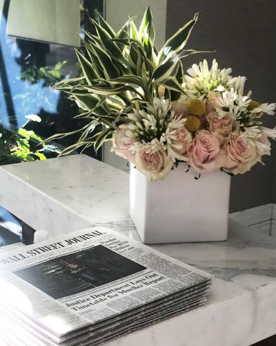 Stack of Wall Street Journals on a marble counter in the Post Oak Hotel lobby