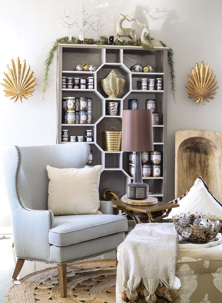 Best shopping in Richmond, Virginia: A store scene from Bridget Beari includes light blue wing chair, bookcase with the shelves arranged in a geometric pattern, and other unique decor.