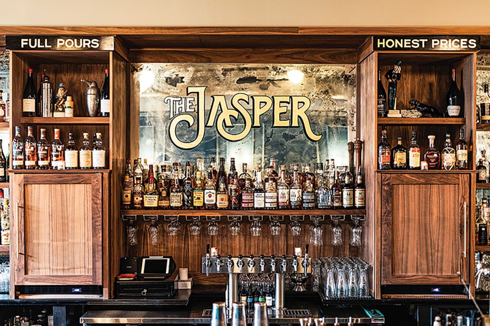 The mirrored and wooden bar of The Jasper