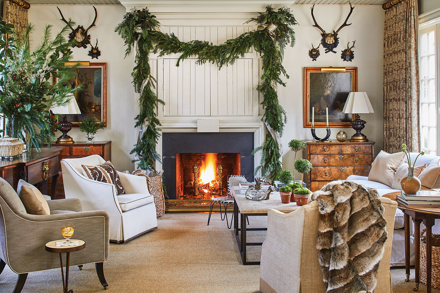 Family room with fireplace, large swag of greenery over fireplace.