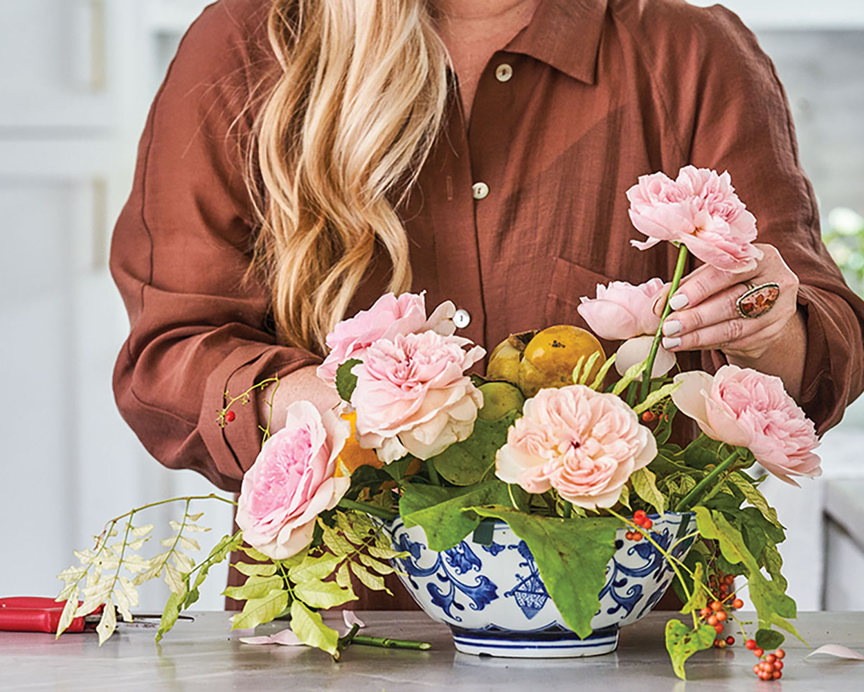 March Cook places stems of garden roses