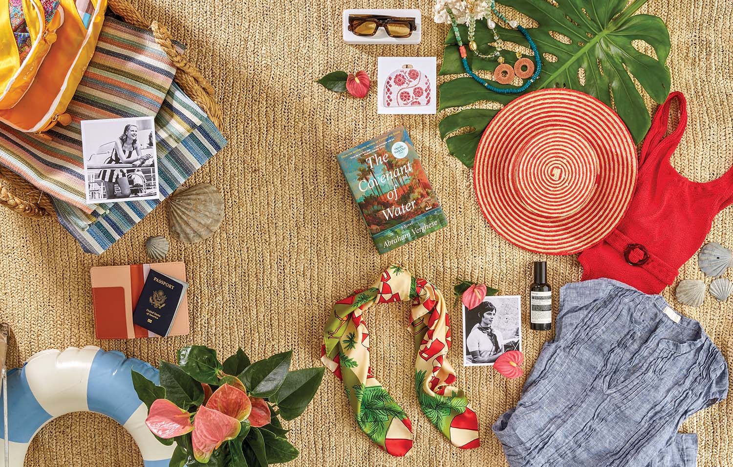 Resort items like hats, sunglasses and swimsuits sit on a rattan mat.