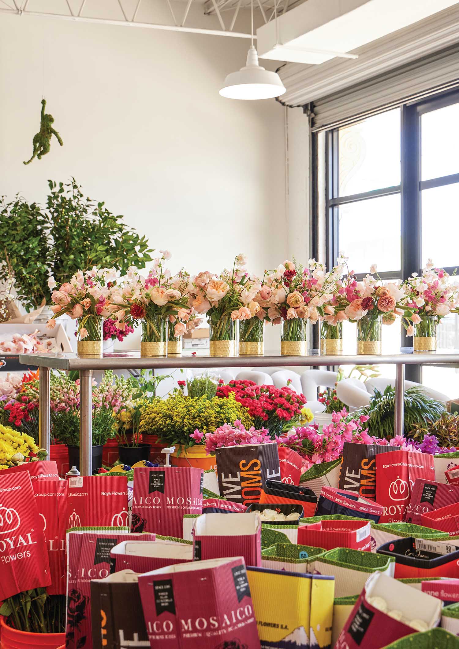 Flower arrangements lined up on a table at Renny & Reed in Palm Beach