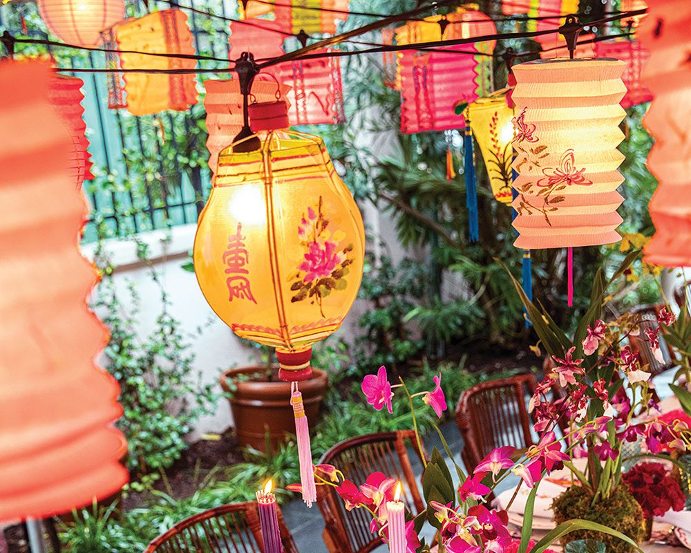 An outdoor party scene with vintage Chinese lanterns aglow
