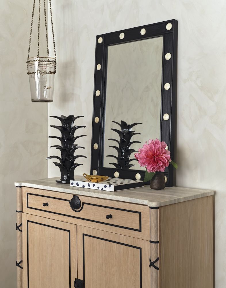 A pale wood cabinet with striking black accents and hardware