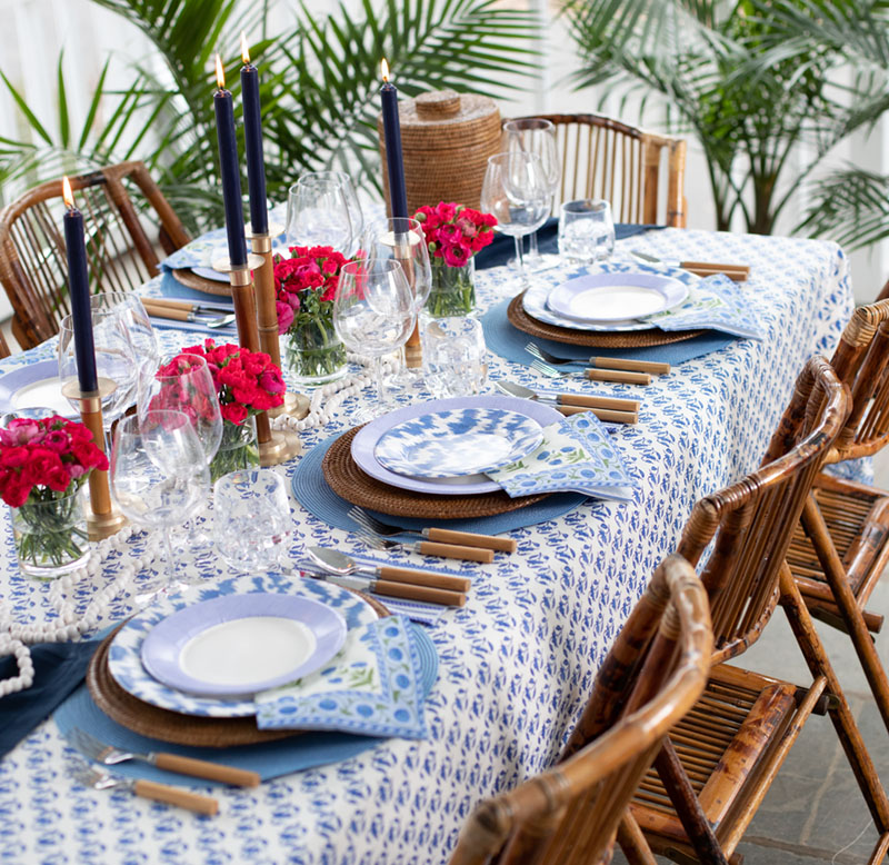 Caspari blue and white table with palm fronds and hot pink flowers