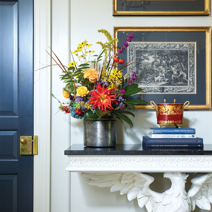 A colorful dahlia arrangement in an entryway.