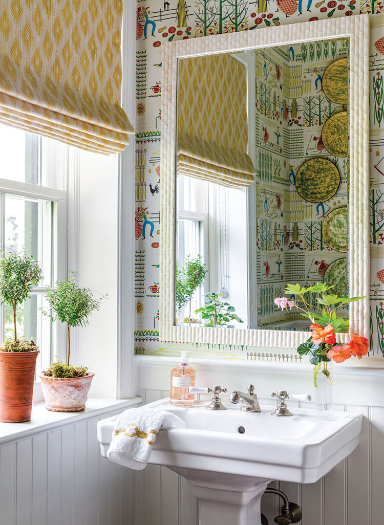 In this powder room, a Thomas Strahan wallpaper aptly named Farmer adds a touch of whimsy.