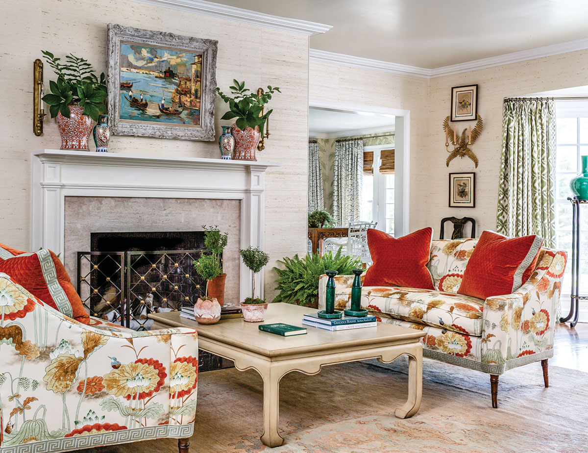 living room designed by James Farmer with grasscloth walls and fireplace.