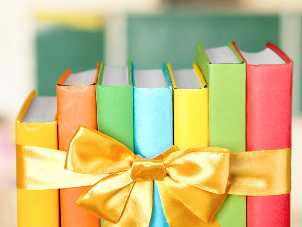 row up books with bright and colorful covers (yellow, orange, green, blue, and red), tied together with a yellow satin bow. Royalty-free stock photo ID: 323036612 Books. By Billion Photos. Shutterstock