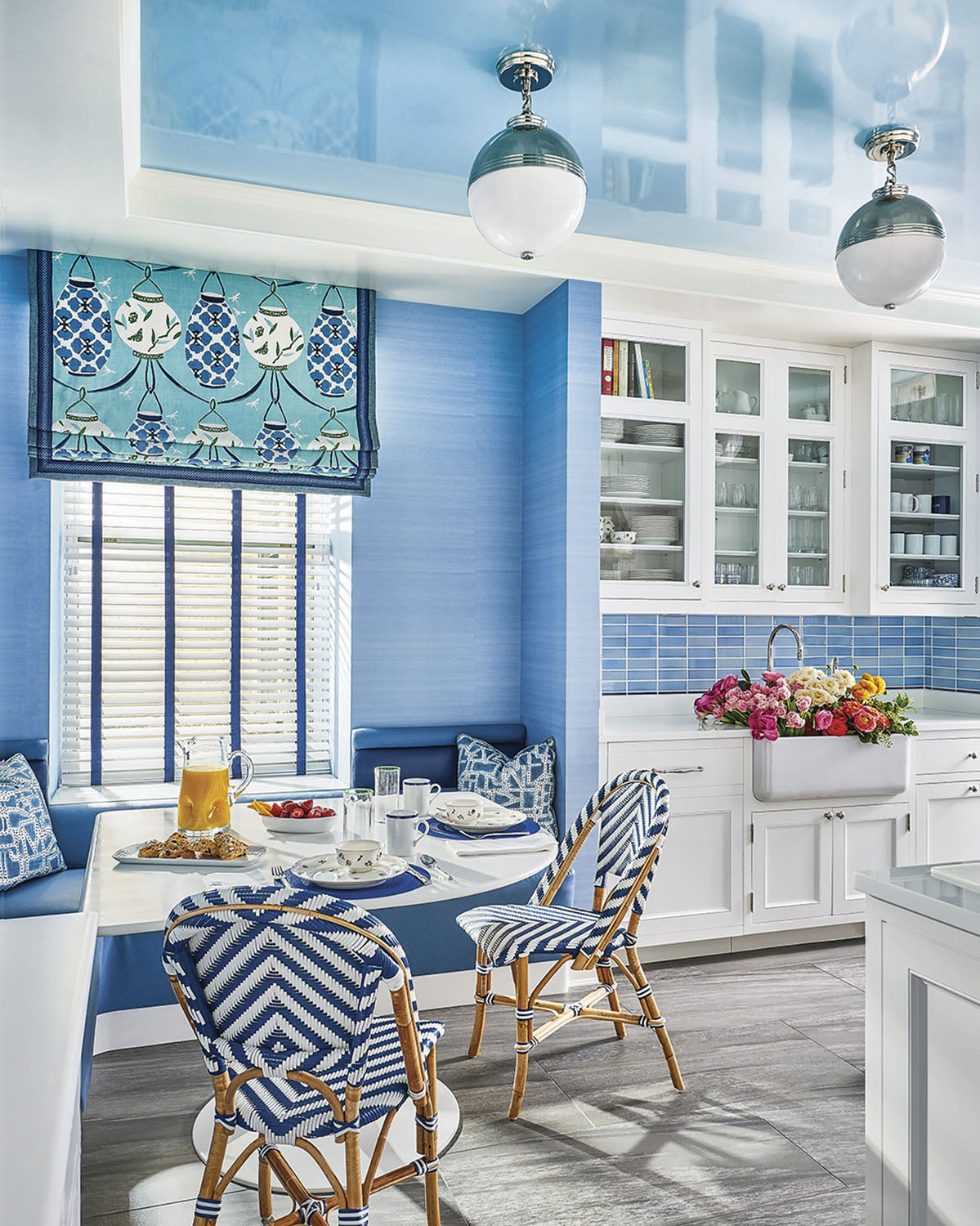 Blue kitchen, sink filled with flowers, interior design by Phillip Thomas