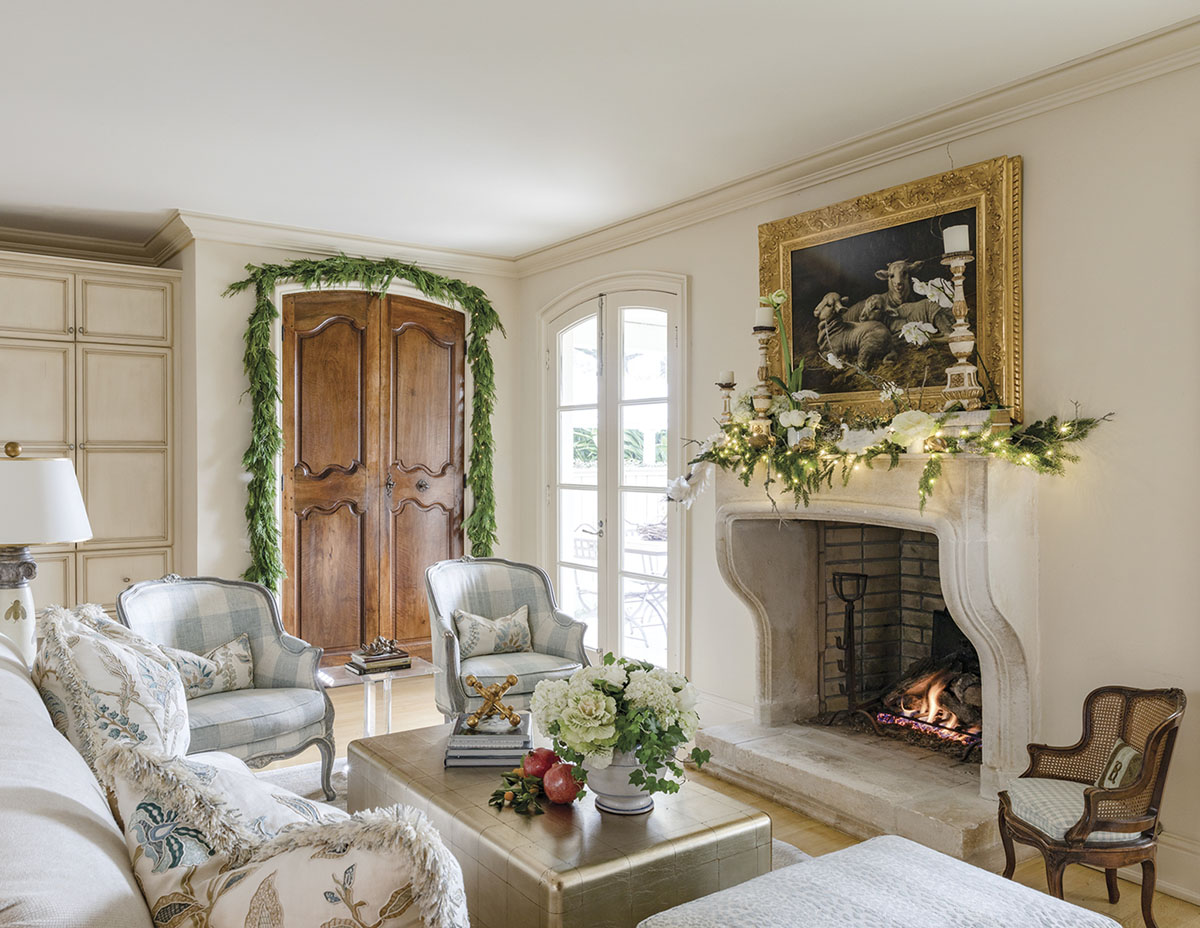 In the New Orleans home of Alix Rico and her husband, Paul, the family room’s limestone fireplace is an authentic representation of the classic château-style fixture common in Provençal architecture. Antique walnut boiserie panels were retrofitted as closet doors. Kumquats, pomegranates, and decorative cabbage enhance the garden-fresh flavor of the room, which is situated between the kitchen and the back porch.