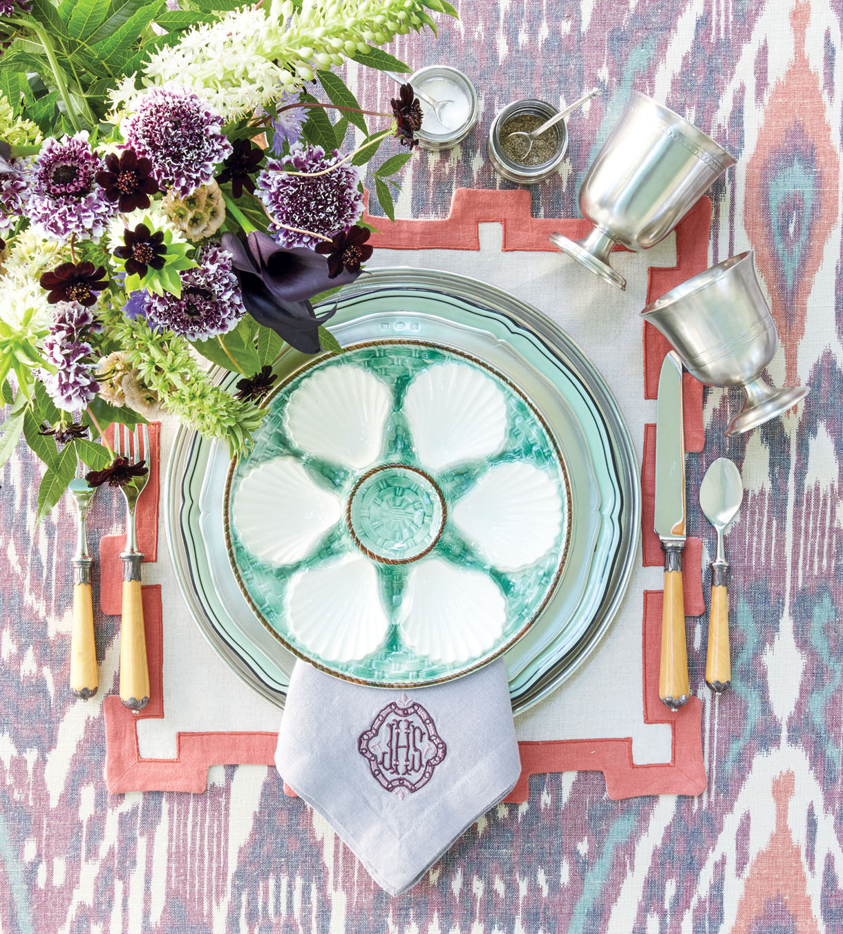 place setting with oyster plate, color palette: purple, coral, and green