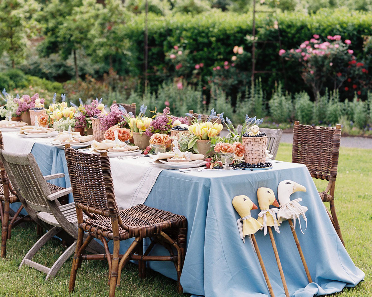 A flower-filled spring luncheon table set in the rose garden at Moss Mountain Farm, created by The Velvet Boxwood for duck, duck, goose-themed children's social