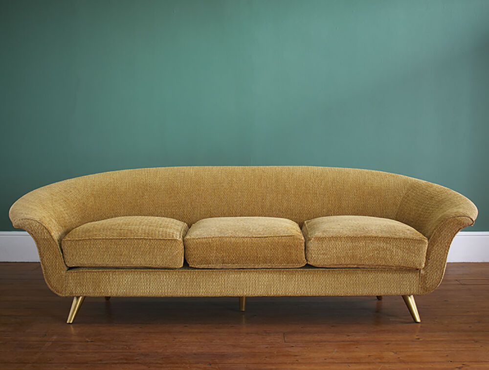 modern sofa upholstered in a gold-colored velvet