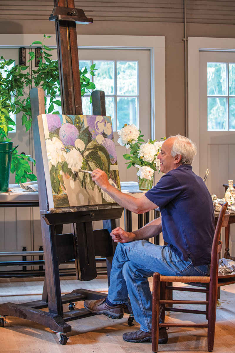 portrait of artist John Funt (the son of Allen Funt of Candid Camera fame) painting flowers in his home studio