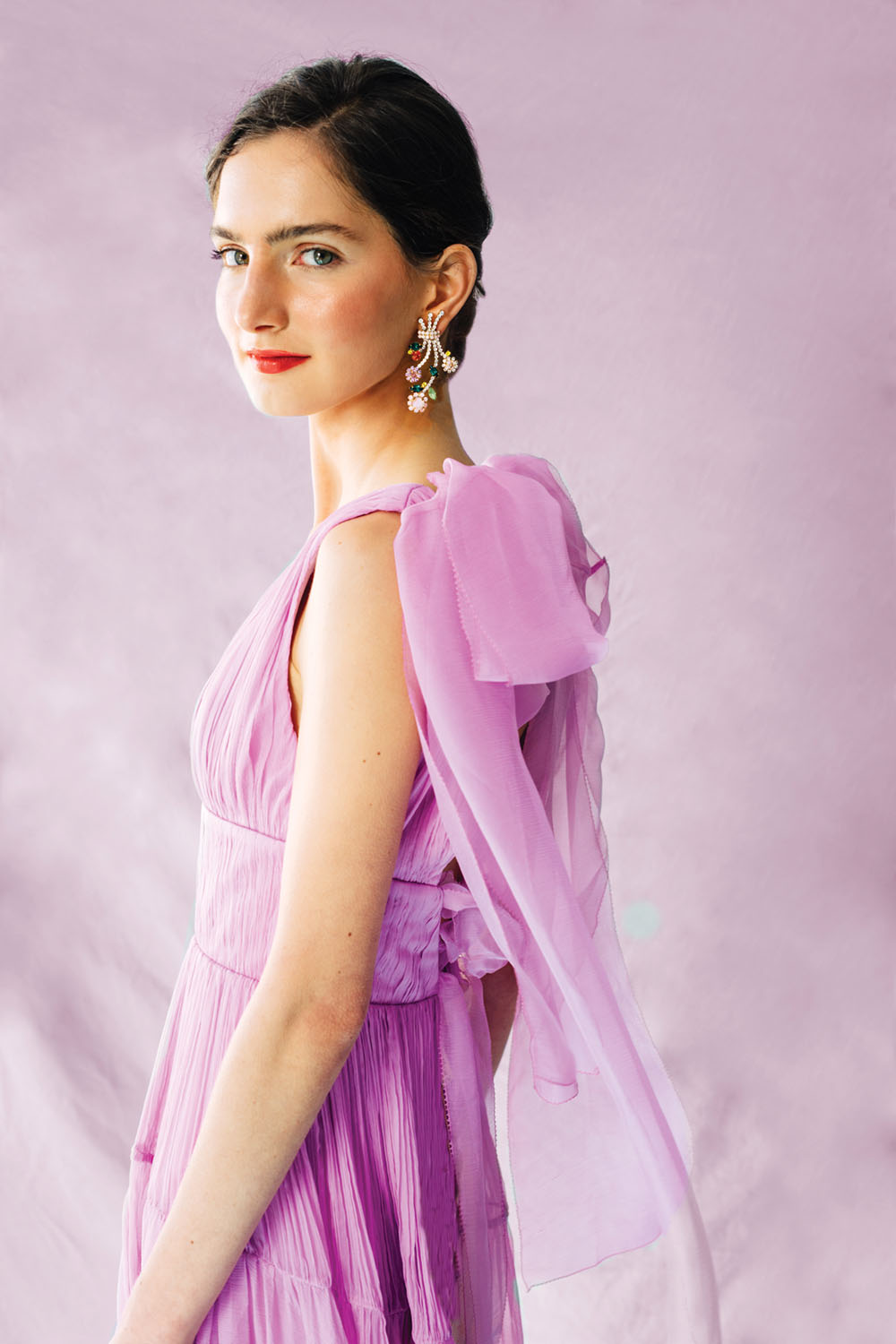 bejeweled floral earrings worn by a model in an elegant chiffon lavender dress