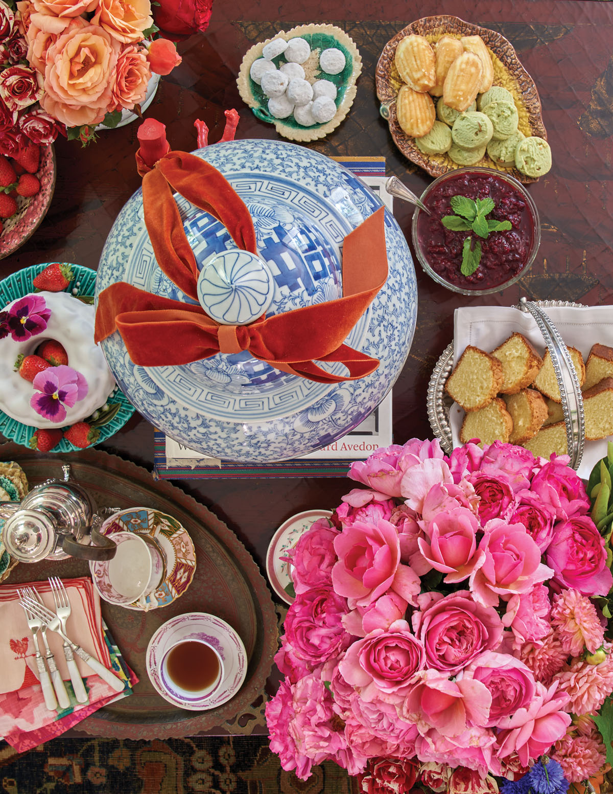 overhead view of the dessert table, including a bouquet of pink roses and a lidded blue-and-white chinoiserie jar