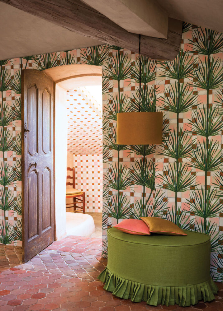 a room papered in a tropical leaf print from Pierre Frey
