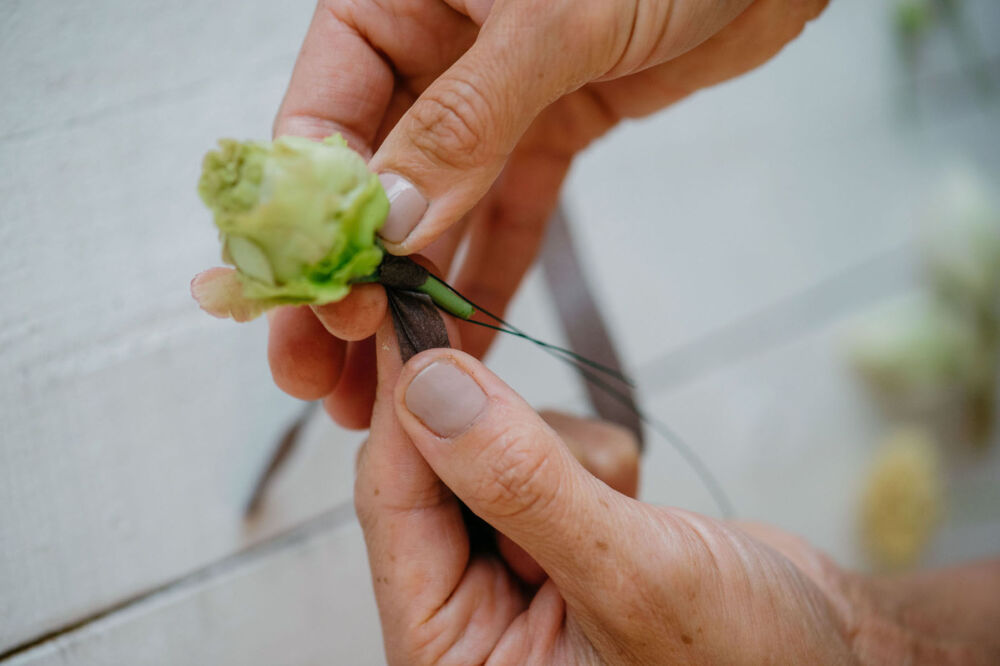 Susan McLeary demonstrates how to wire a flower stem a rosebud stem using the piercing method