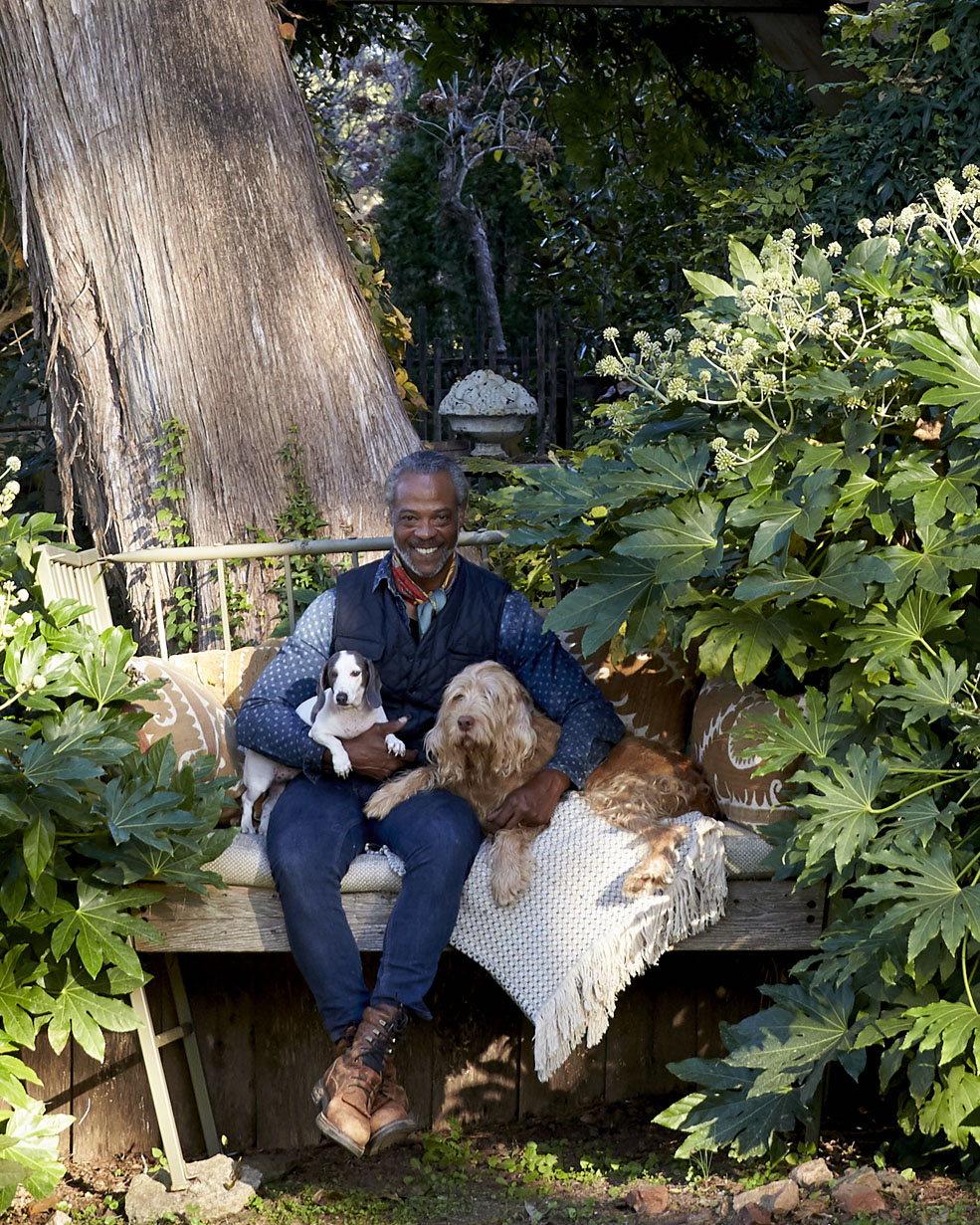Keith Robinson with his dogs, sitting in the garden