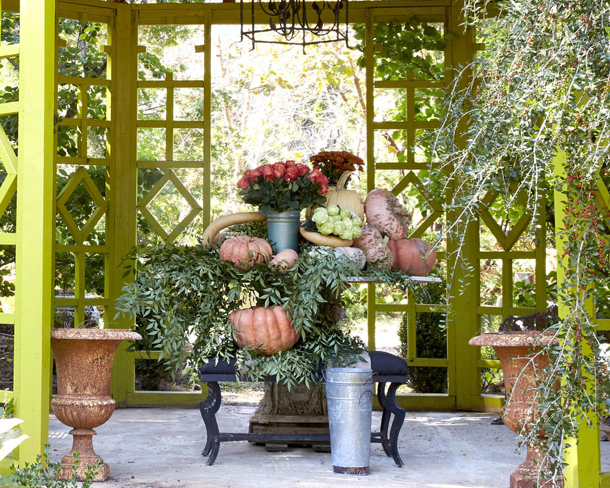 Branches visually connect a two-level harvest display inside a garden folly.