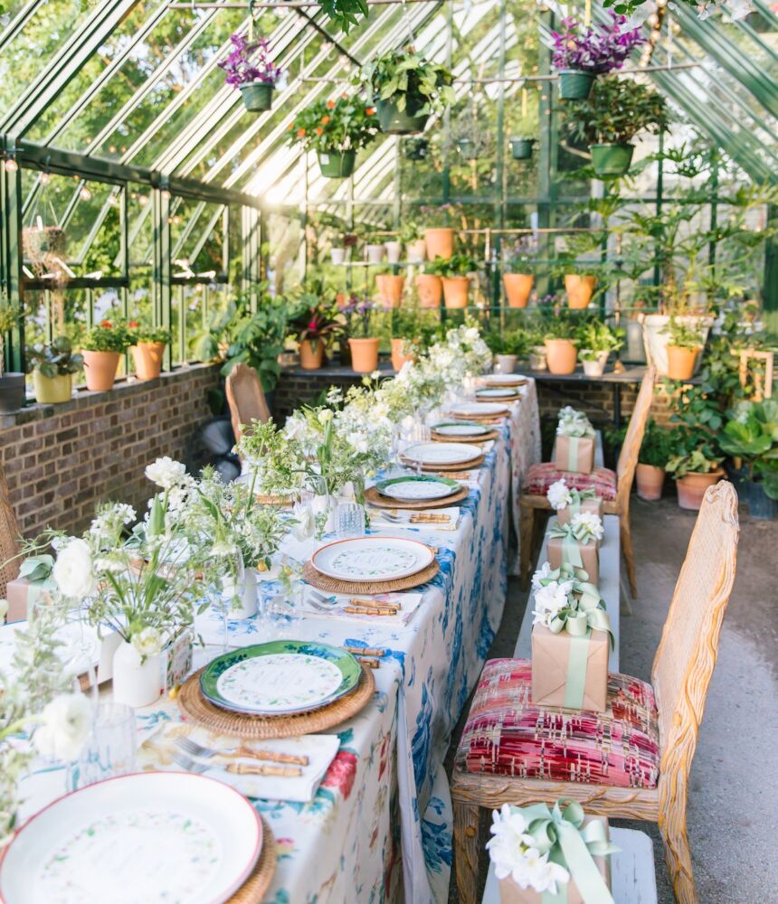 Table in greenhouse set for a Sister Parish party