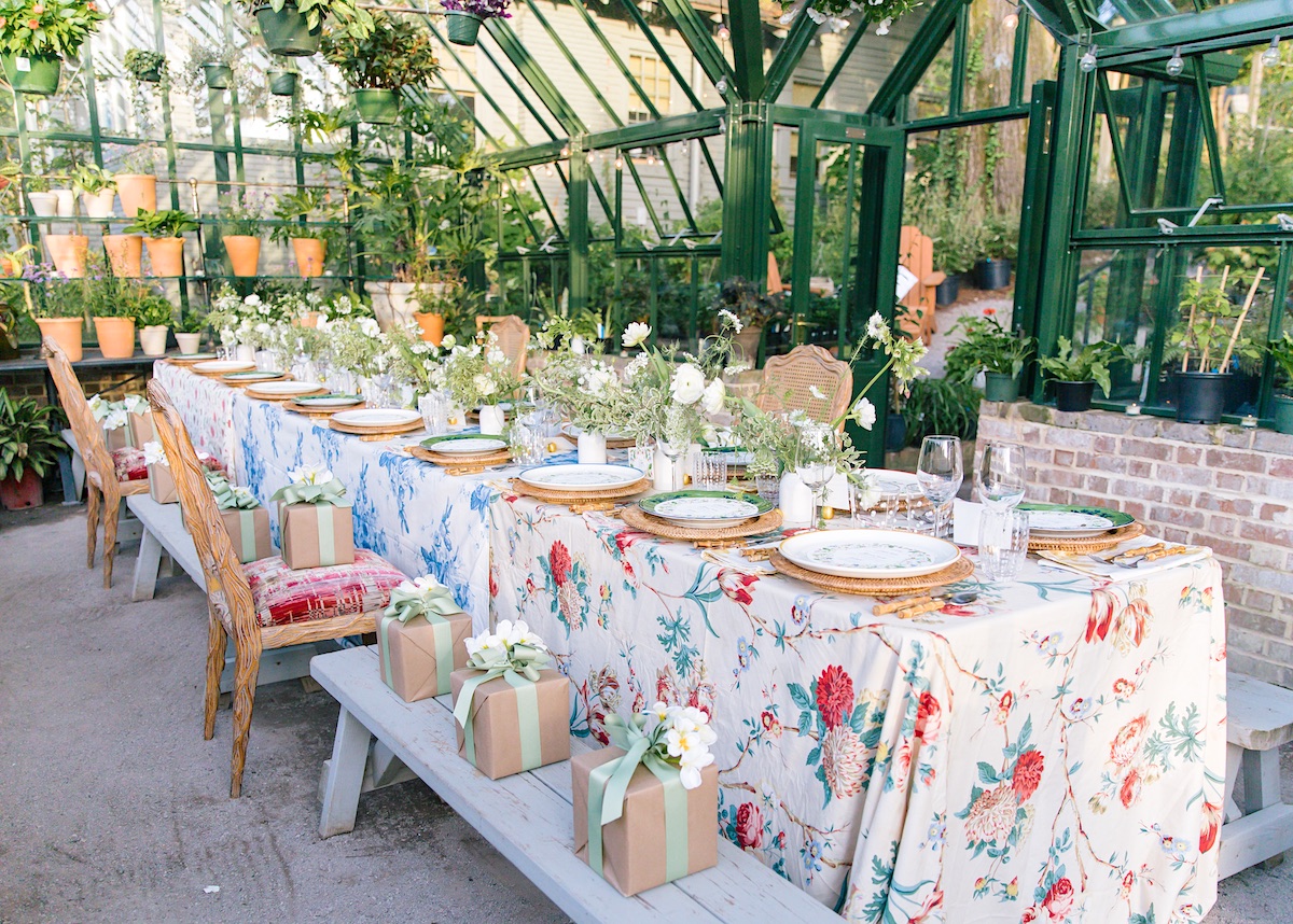 Table in greenhouse set for Sister Parish party