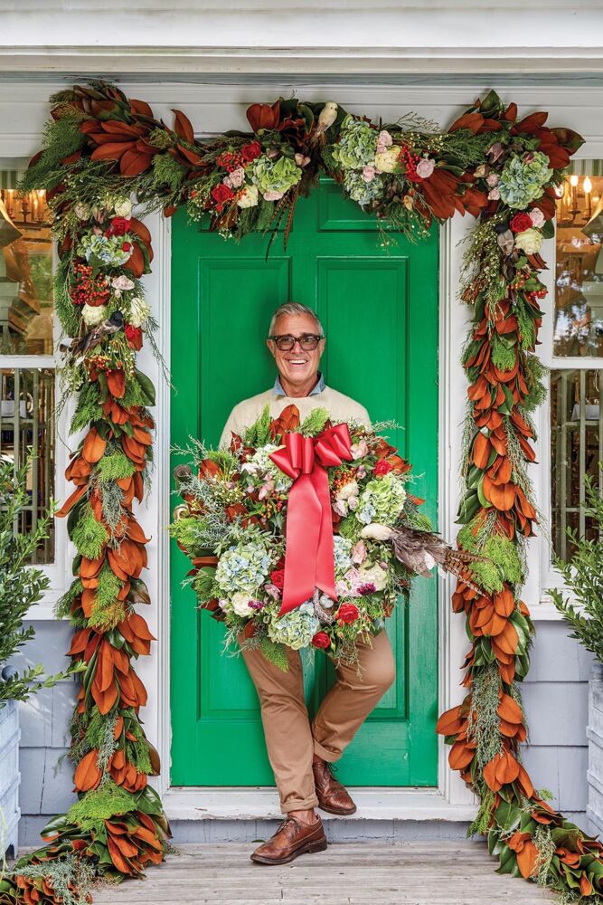 floral designer holding handmade wreath