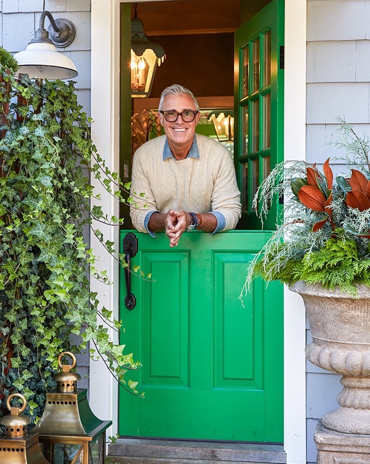 Michael Giannelli stands behind a green dutch door.