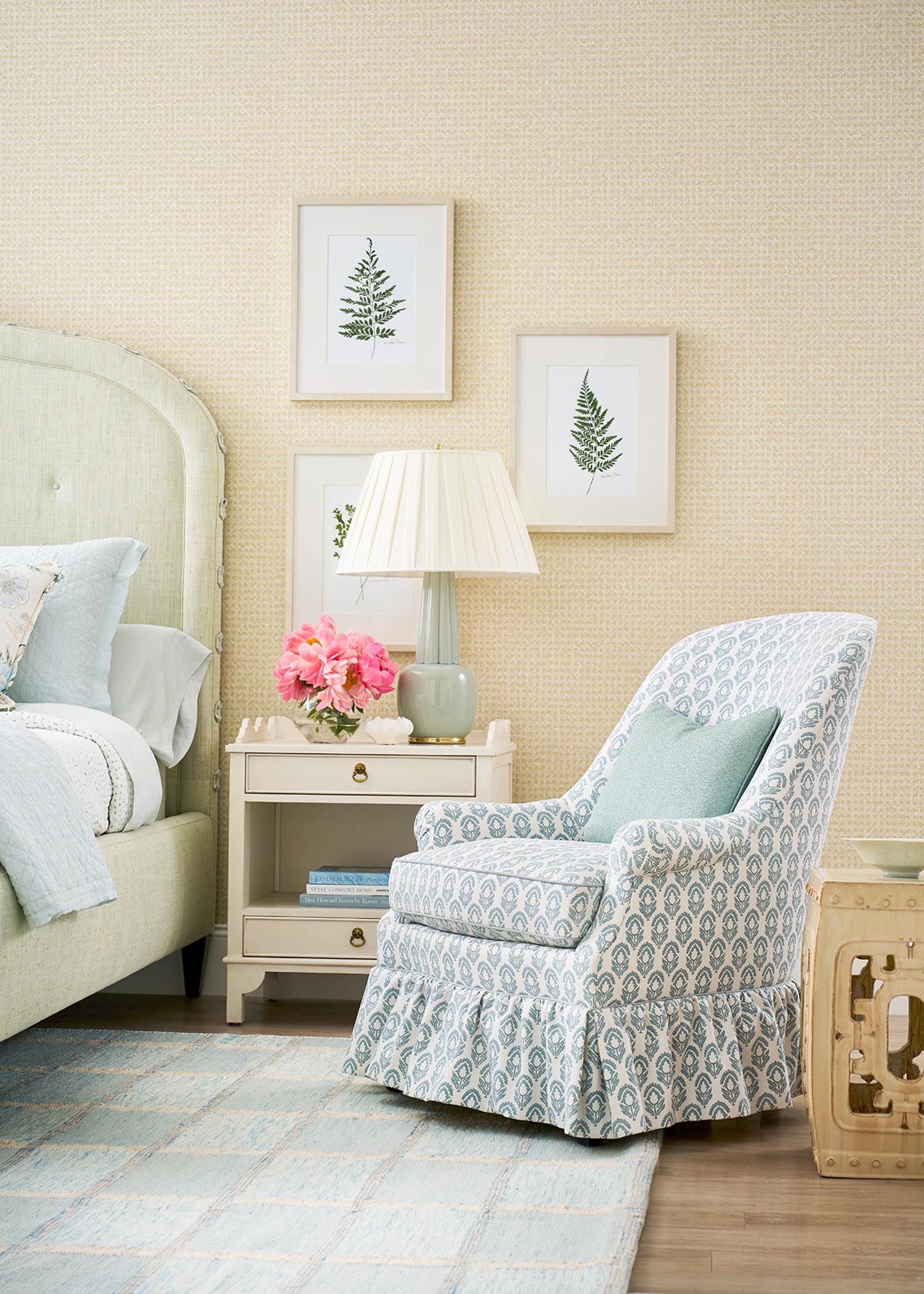 A pastel blue ruffled chair sits in a bedroom.