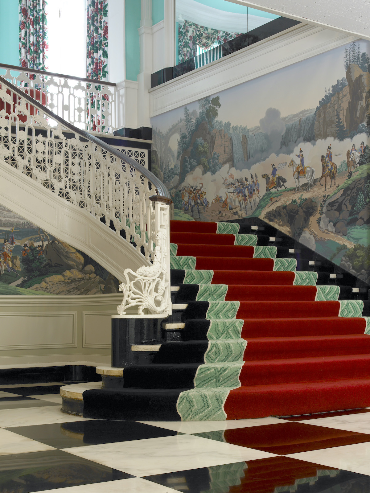 Red velvet carpet covers a staircase.