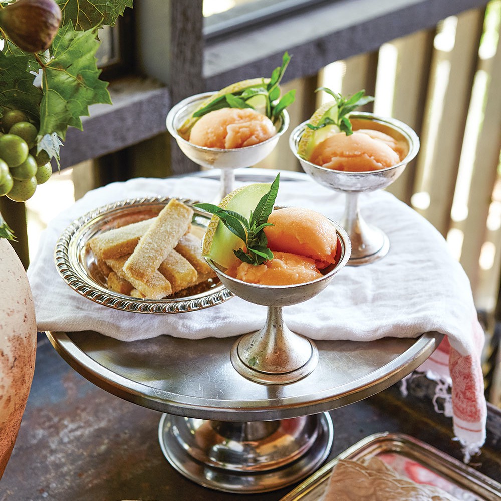 Cantaloupe sorbet served in silver coupes found at New Orleans’ Lucullus Antiques rounds out a summer menu at Pardis and Frank Stitt's Alabama farm.